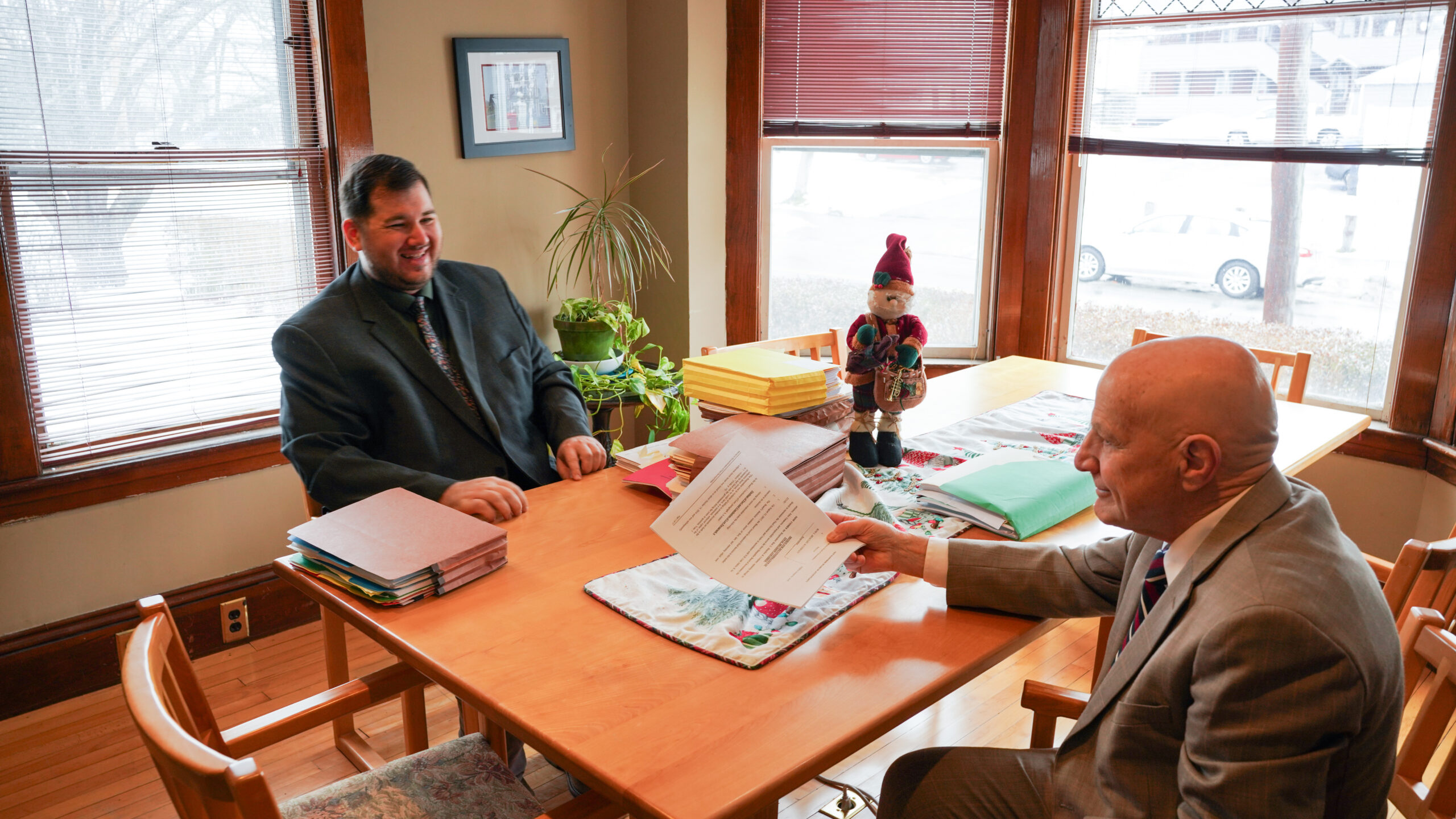 A diverse group of four professionals collaborating at a desk in a modern office.