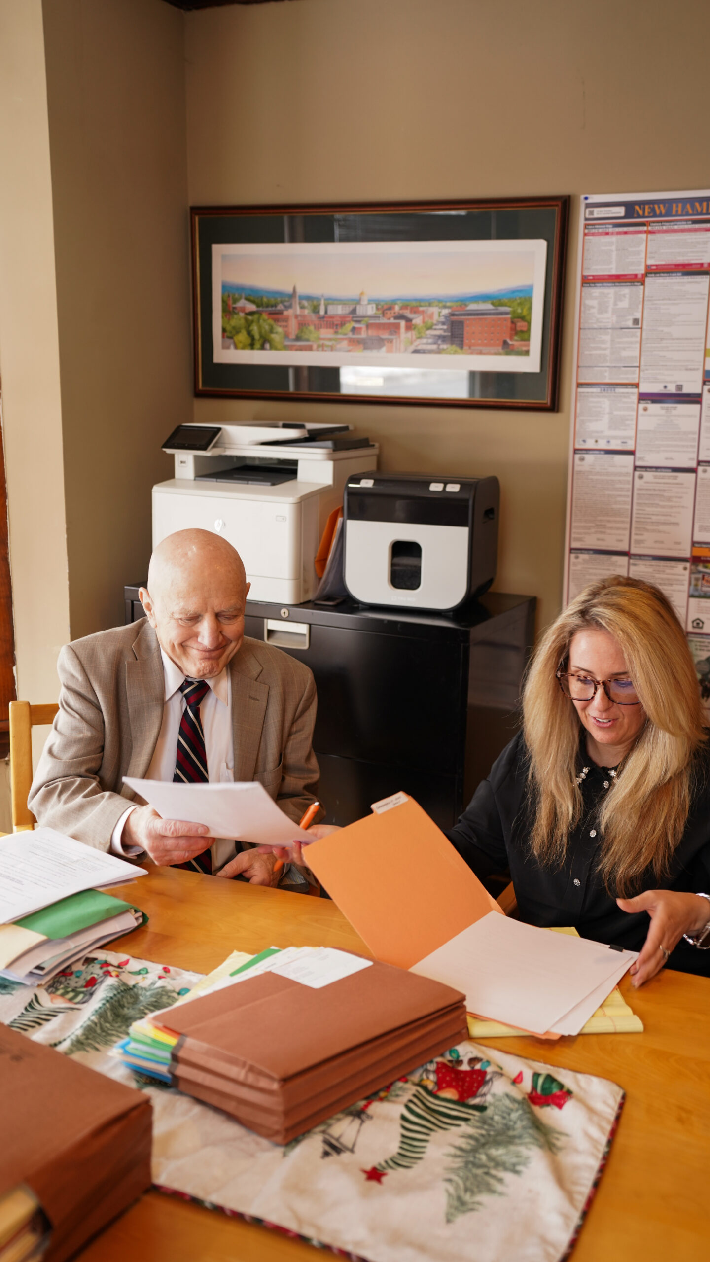 A diverse group of four professionals collaborating at a desk in a modern office.