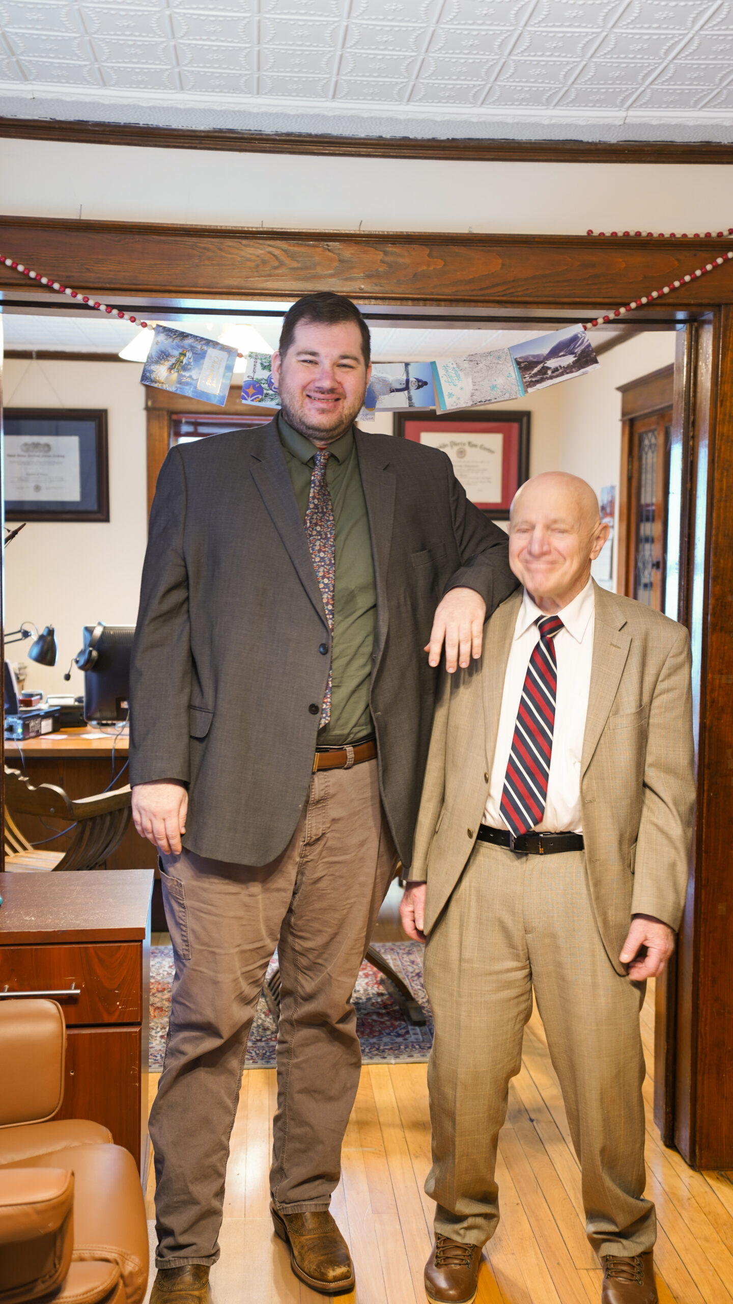 A diverse group of four professionals collaborating at a desk in a modern office.